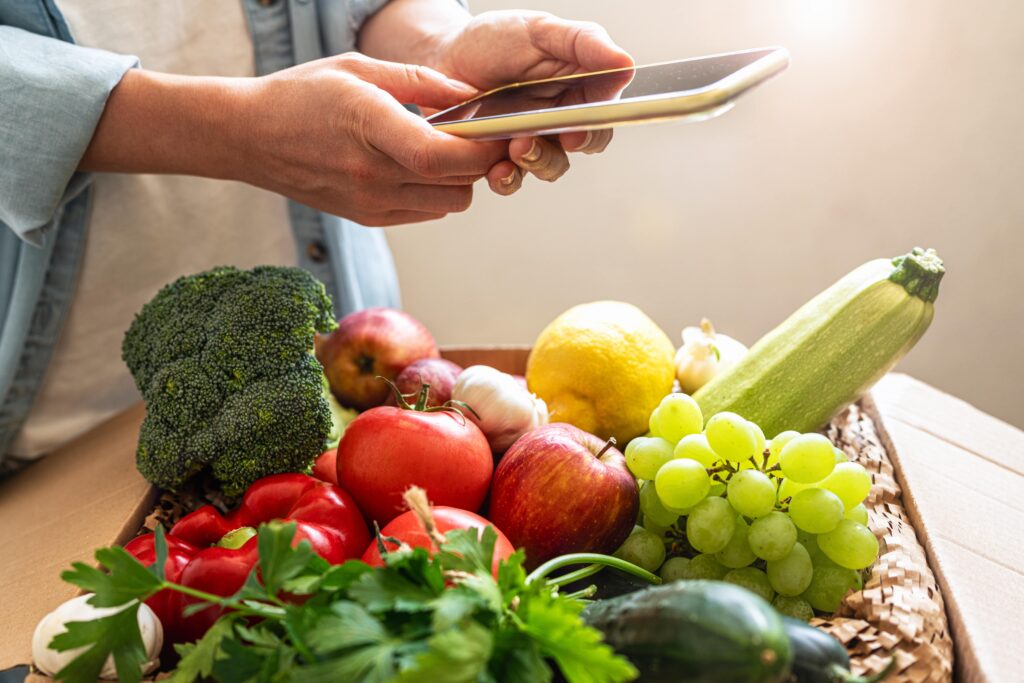 Professional chef using their phone to easily order wholesale vegetables online.