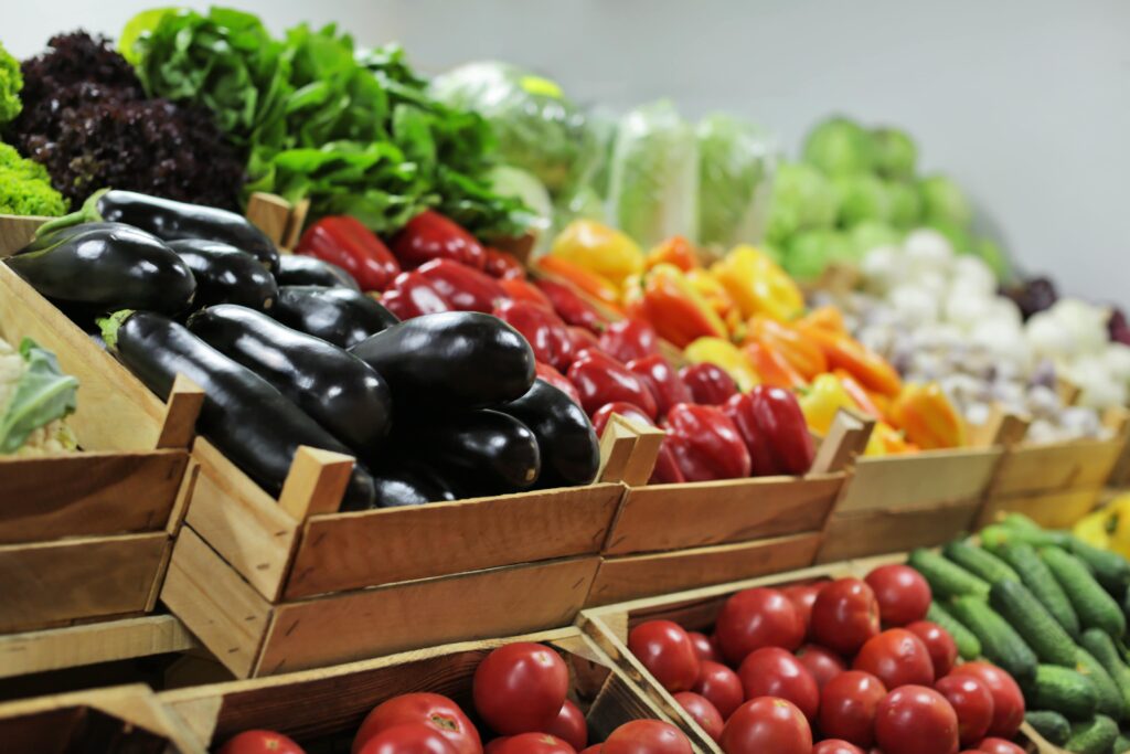 Seasonal wholesale vegetables in wooden baskets.