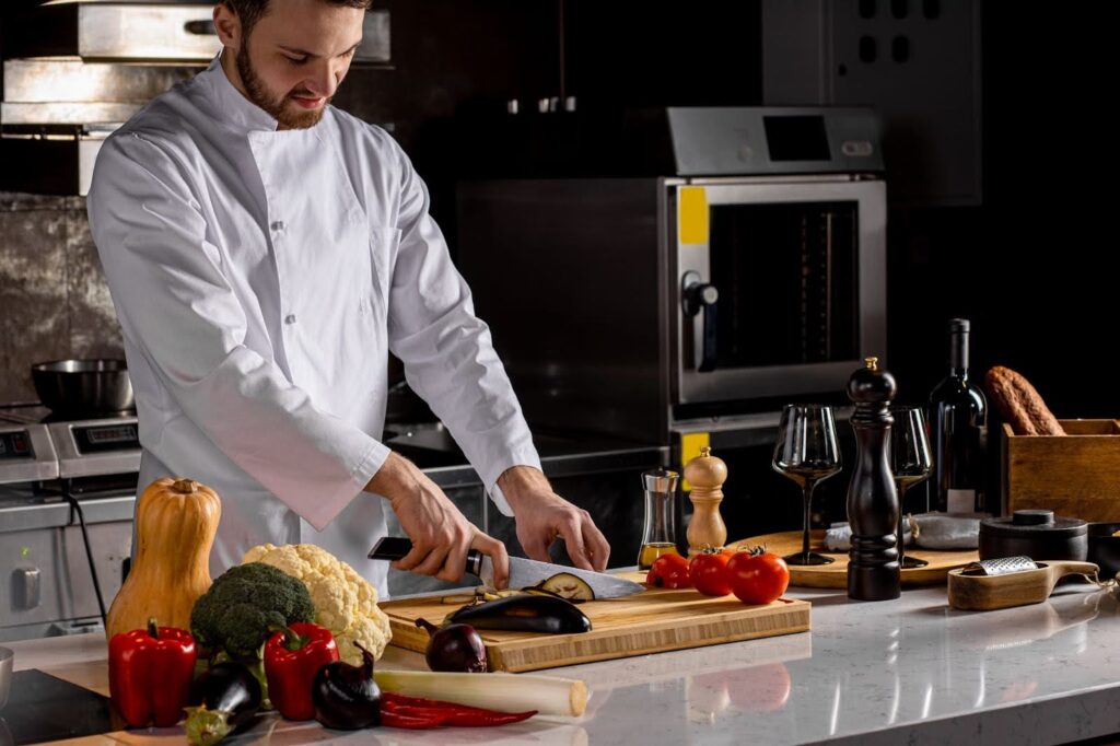 A professional chef in whites preparing a meal