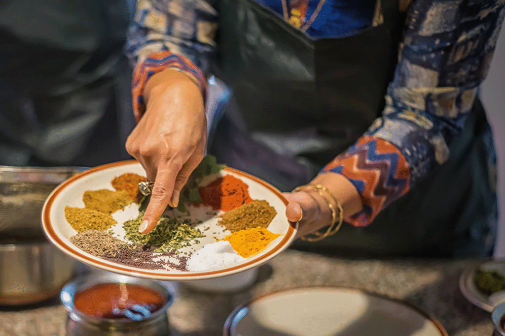 Chef laying out spices on a plate ready to use in cooking