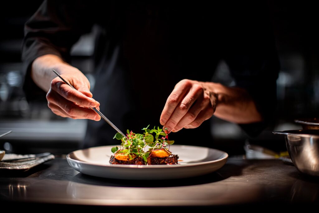 Chef plating a gourmet dish.