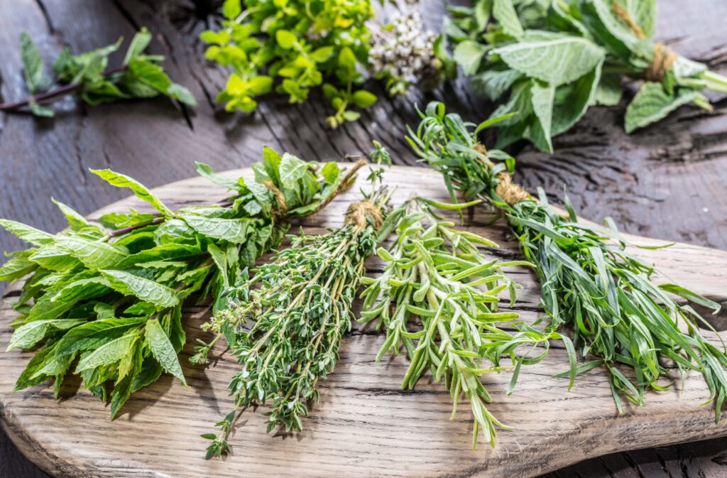 Fresh herbs arranged on wooden board